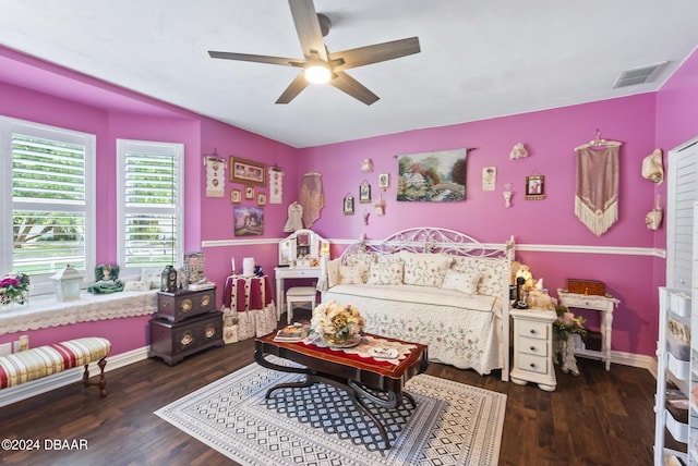 bedroom featuring ceiling fan, wood finished floors, visible vents, and baseboards