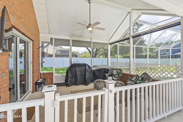 view of patio featuring a lanai, ceiling fan, grilling area, and fence