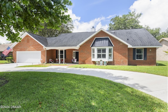 single story home with a chimney, a front lawn, concrete driveway, and brick siding