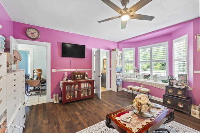 interior space featuring ceiling fan, baseboards, and wood finished floors