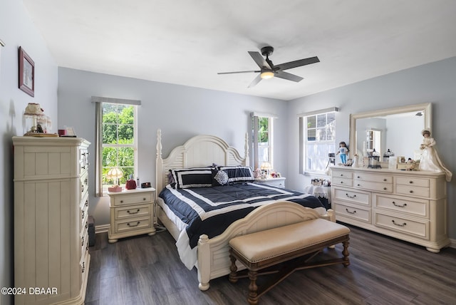 bedroom with dark wood-type flooring, baseboards, and a ceiling fan