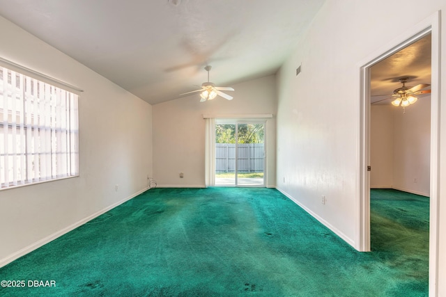 carpeted spare room with ceiling fan and vaulted ceiling