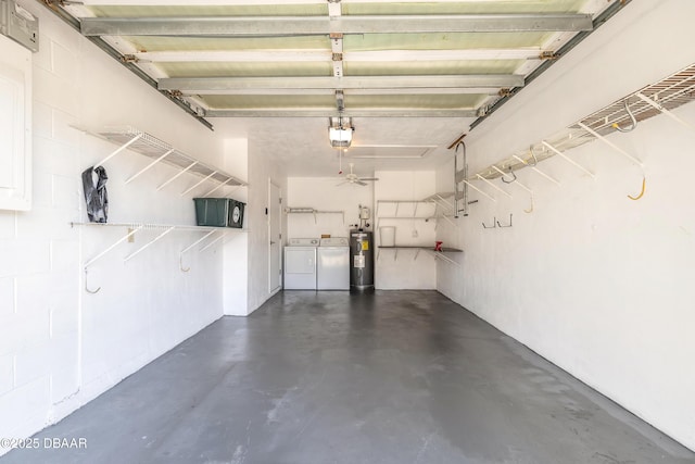 garage featuring water heater, a garage door opener, and washer and dryer