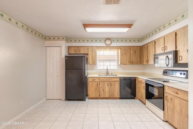 kitchen with light tile patterned floors, sink, and black appliances