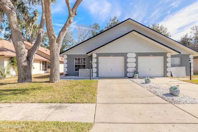 ranch-style house featuring a garage and a front lawn