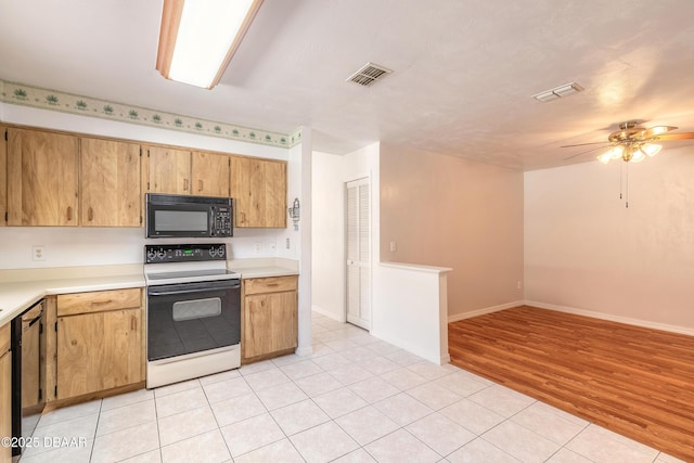 kitchen featuring ceiling fan, dishwashing machine, light tile patterned floors, and electric range