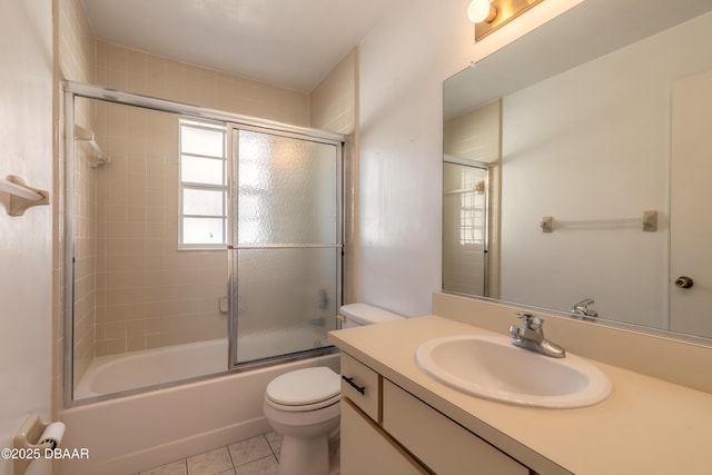 full bathroom with enclosed tub / shower combo, toilet, tile patterned floors, and vanity