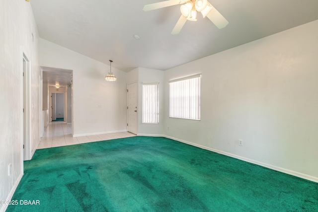 empty room featuring ceiling fan, light colored carpet, and lofted ceiling