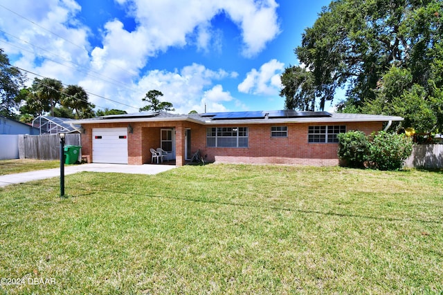 single story home featuring a front lawn, a garage, and solar panels