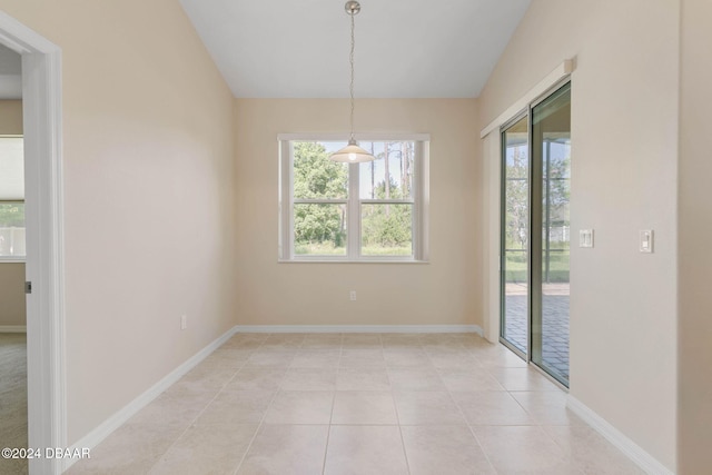 unfurnished dining area featuring light tile patterned flooring