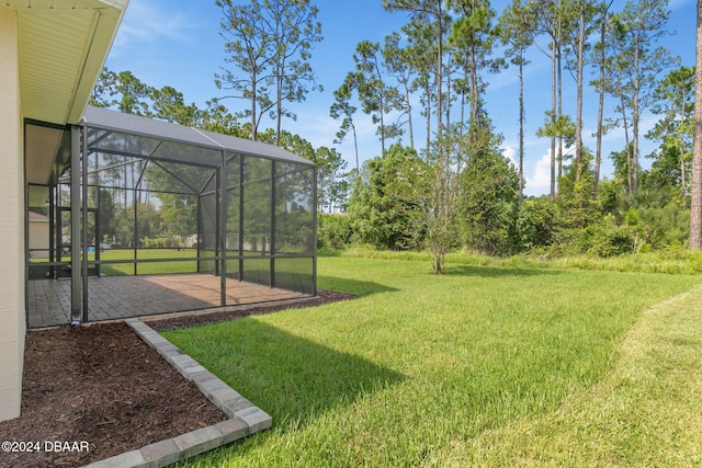 view of yard with a patio and glass enclosure