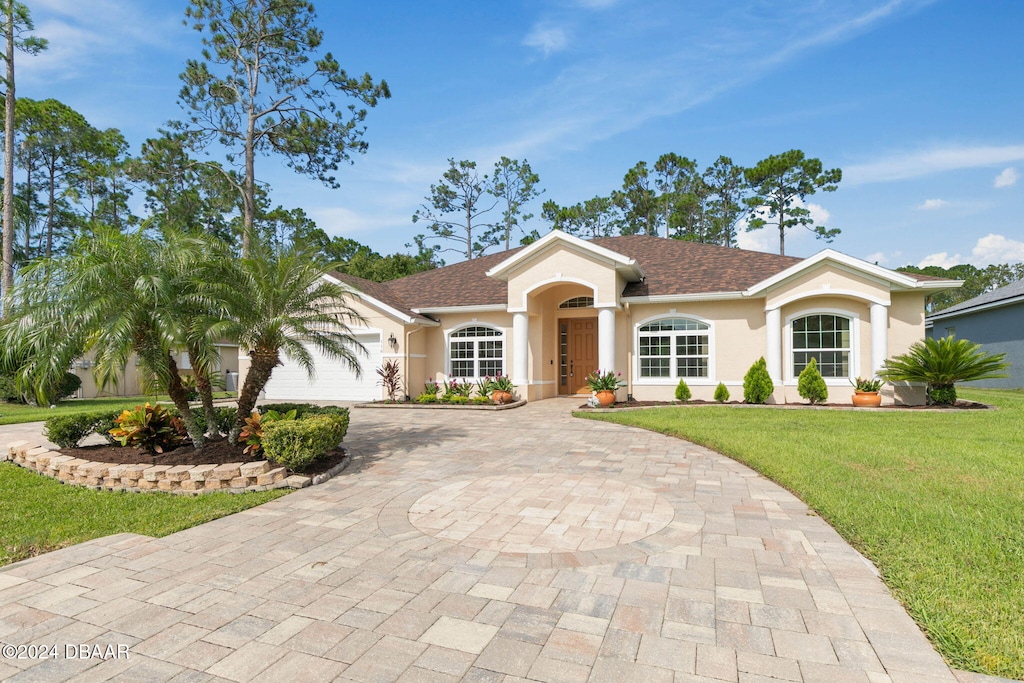 116 Eric Dr, Palm Coast, FL 32164 - ranch-style home featuring a front yard and a garage