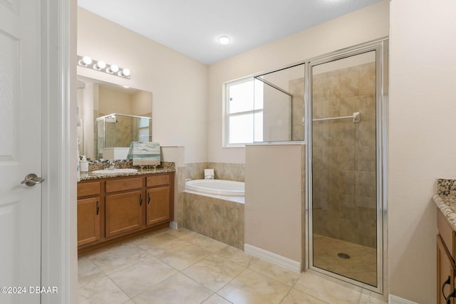 bathroom with tile patterned floors, vanity, and shower with separate bathtub