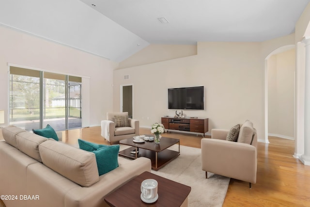 living room featuring light hardwood / wood-style floors and lofted ceiling