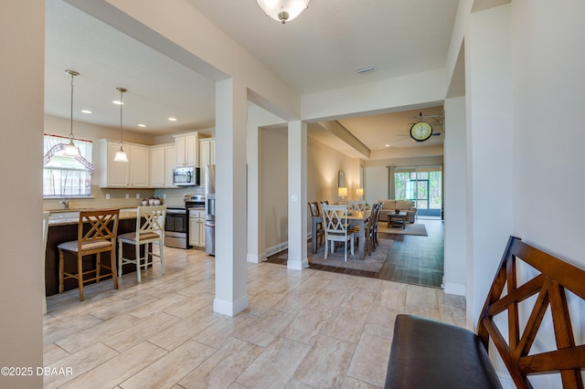 dining space with light wood-type flooring