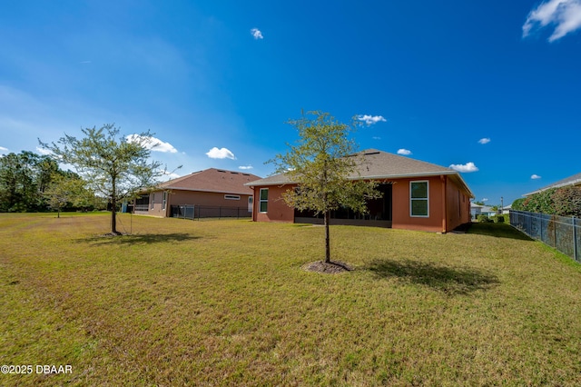 rear view of house with a yard