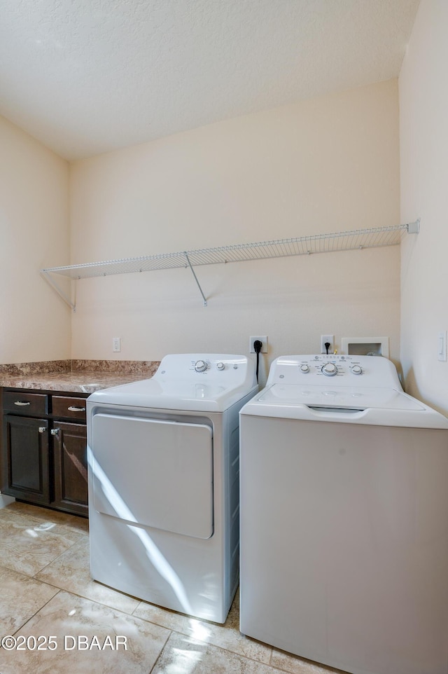 laundry area with cabinets and washing machine and dryer