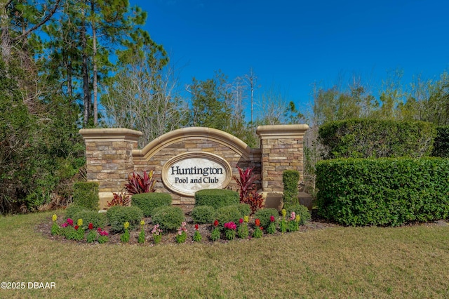 community / neighborhood sign with a lawn