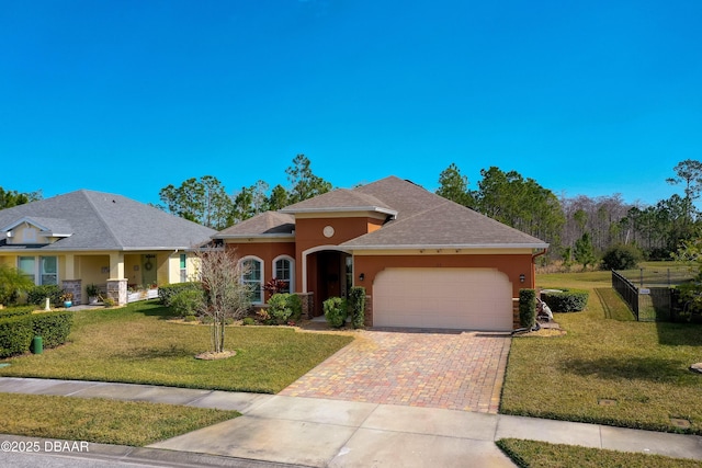 view of front facade with a garage and a front yard