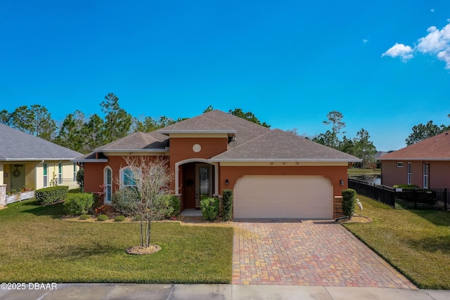 view of front of property with a garage and a front lawn