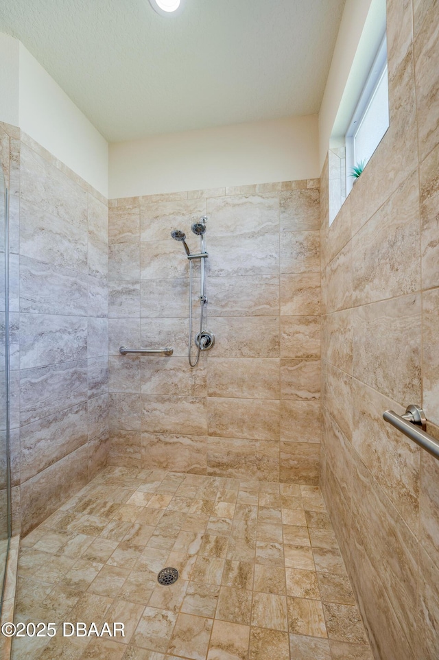 bathroom with tiled shower