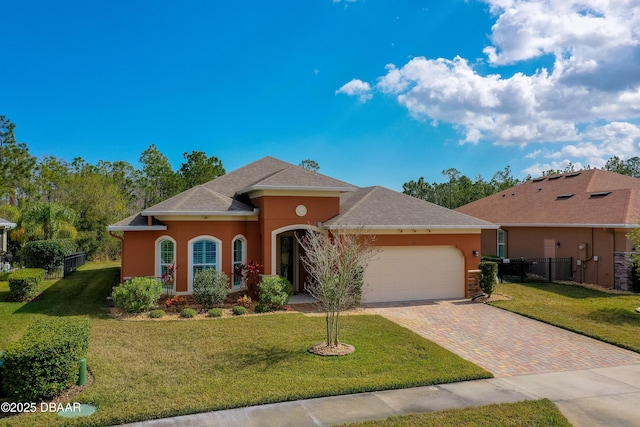 view of front of house featuring a garage and a front yard