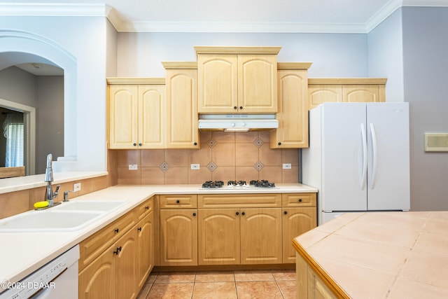 kitchen with decorative backsplash, light brown cabinetry, white appliances, sink, and light tile patterned flooring