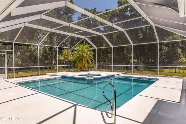 view of swimming pool with a lanai, a patio area, and an in ground hot tub