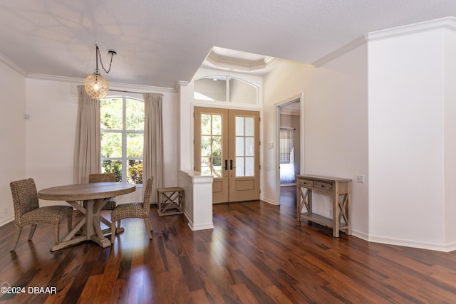 dining space featuring dark hardwood / wood-style flooring, crown molding, french doors, and a textured ceiling