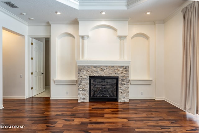 unfurnished living room with a fireplace, a textured ceiling, dark hardwood / wood-style floors, and ornamental molding