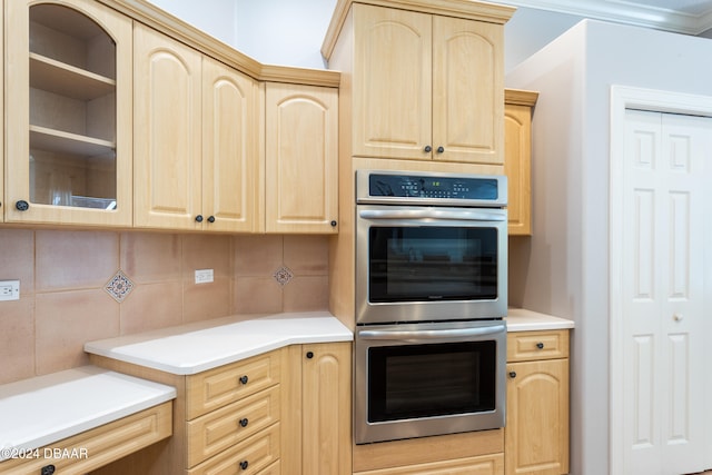 kitchen featuring light brown cabinets, crown molding, stainless steel double oven, and backsplash