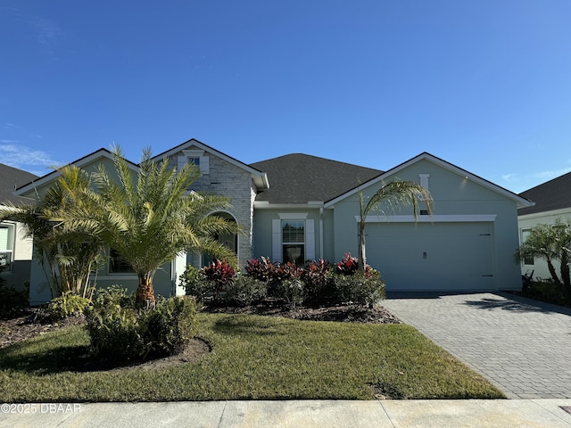 view of front of property with a front yard and a garage