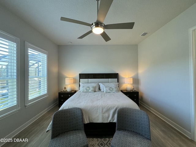 bedroom featuring ceiling fan and dark hardwood / wood-style flooring