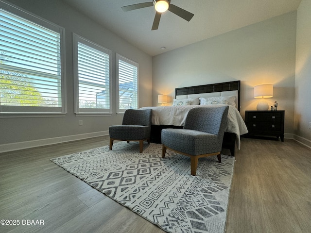 bedroom with ceiling fan, lofted ceiling, and hardwood / wood-style flooring