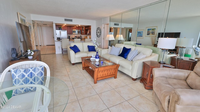 living room featuring light tile patterned floors and visible vents