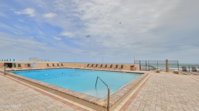 view of pool featuring fence