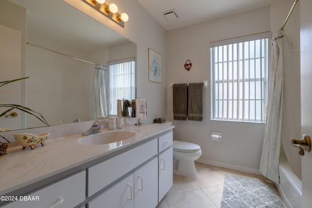 full bathroom with toilet, a wealth of natural light, vanity, and tile patterned floors