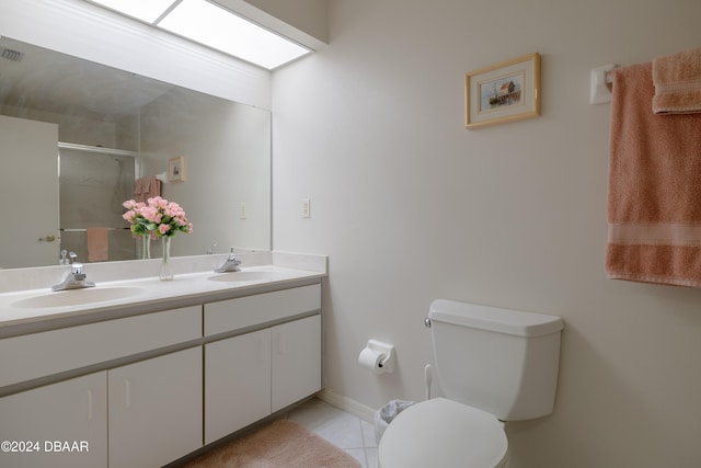 bathroom featuring toilet, an enclosed shower, vanity, and tile patterned floors