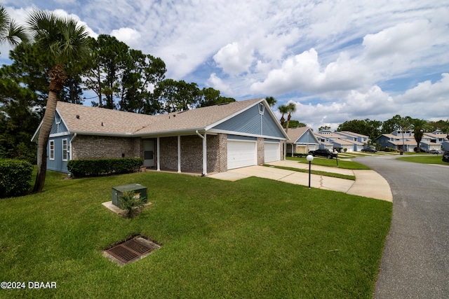 view of front of property with a garage and a front lawn