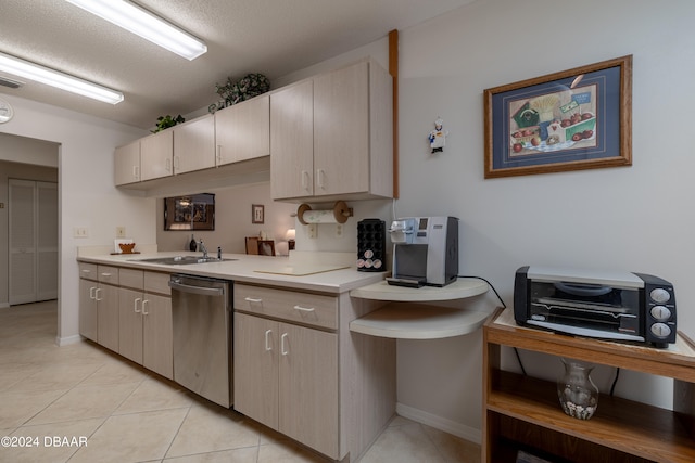 kitchen with stainless steel dishwasher, a textured ceiling, sink, and light tile patterned floors