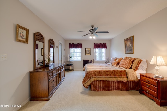 bedroom featuring light colored carpet and ceiling fan