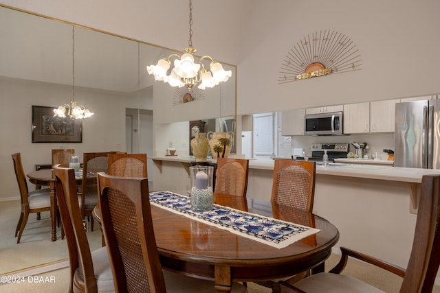 carpeted dining room with an inviting chandelier and high vaulted ceiling