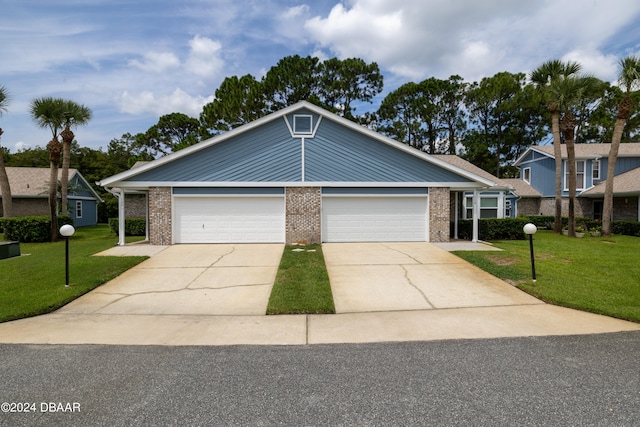 view of front of house featuring a garage and a front yard