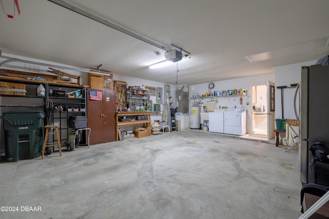 garage with a garage door opener, electric water heater, a workshop area, washing machine and clothes dryer, and stainless steel refrigerator