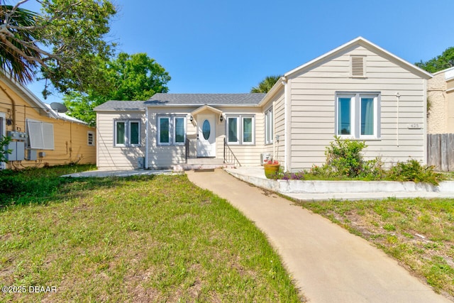 ranch-style house featuring fence and a front yard