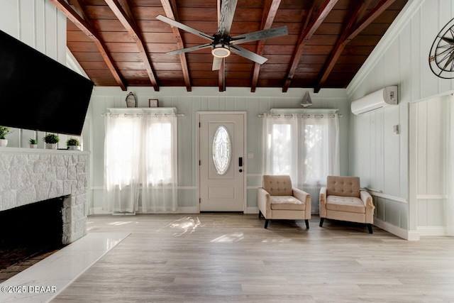 foyer entrance with a ceiling fan, lofted ceiling with beams, a wall mounted AC, wood ceiling, and a fireplace