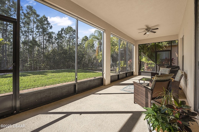 sunroom featuring a ceiling fan and a healthy amount of sunlight