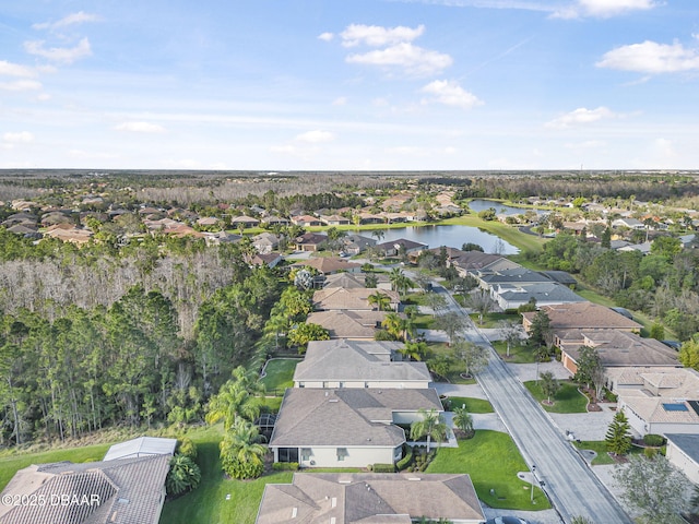 birds eye view of property with a water view and a residential view