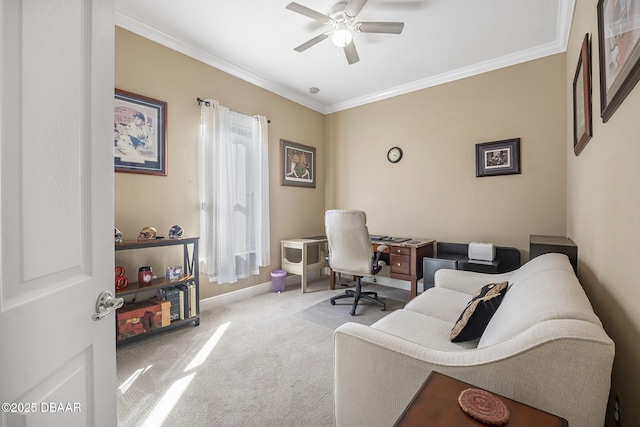 home office with carpet floors, baseboards, ornamental molding, and a ceiling fan