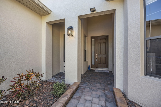 doorway to property with stucco siding